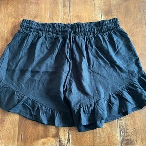 Elastic tie waist shorts with ruffles on the legs.